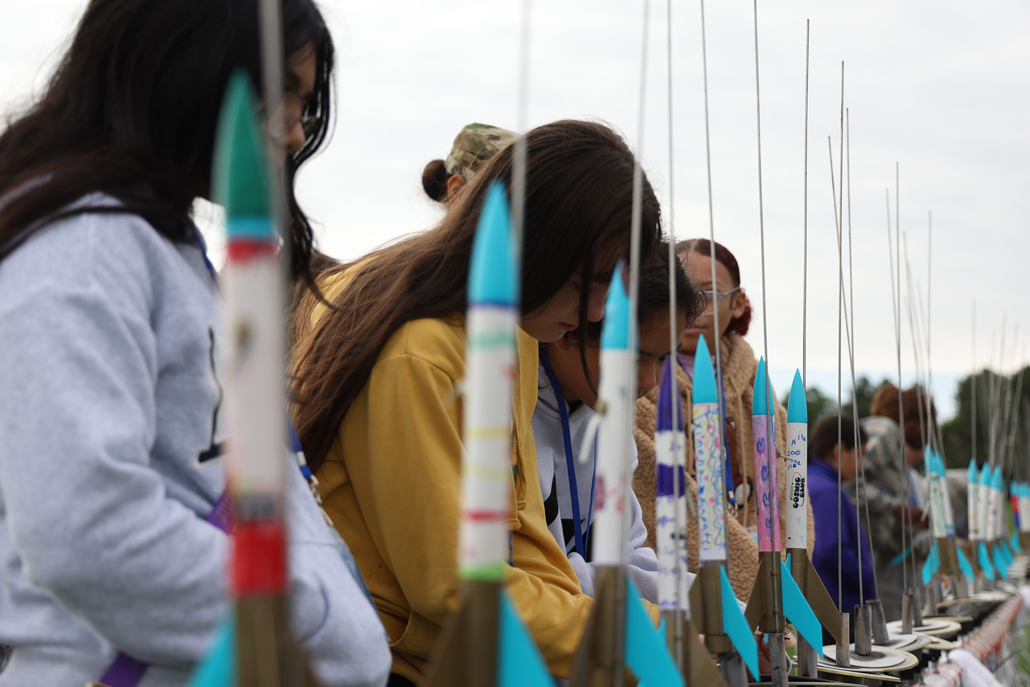 Students make final adjustments to their model rockets before launch.